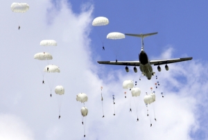 Russian soldiers make parachute jumps during a training session for the upcoming joint anti-terror military drill in Taonan